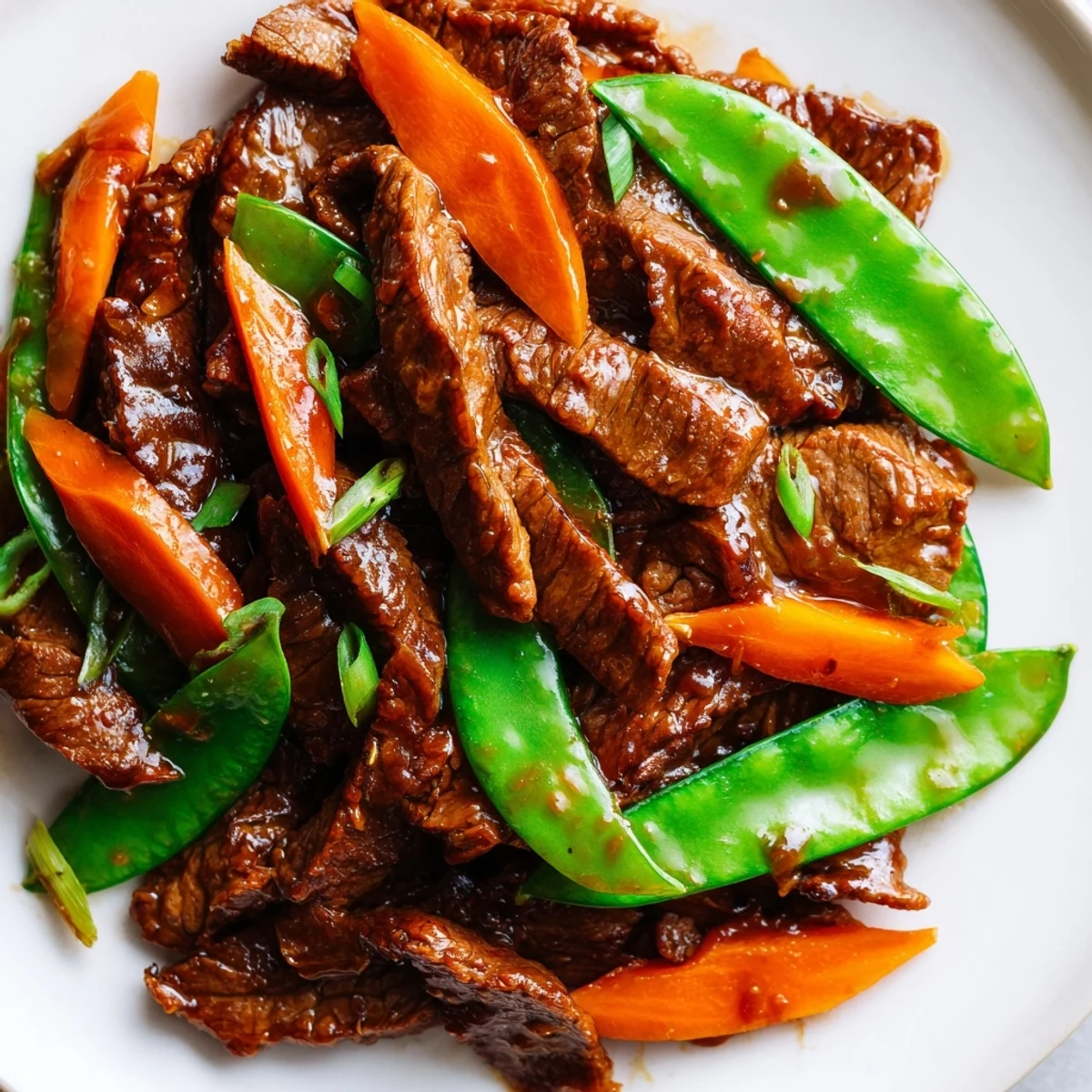 Tender beef, crisp veggies, and sticky Asian-inspired sauce make this Beef Stir Fry with Snow Peas and Carrots look irresistible.