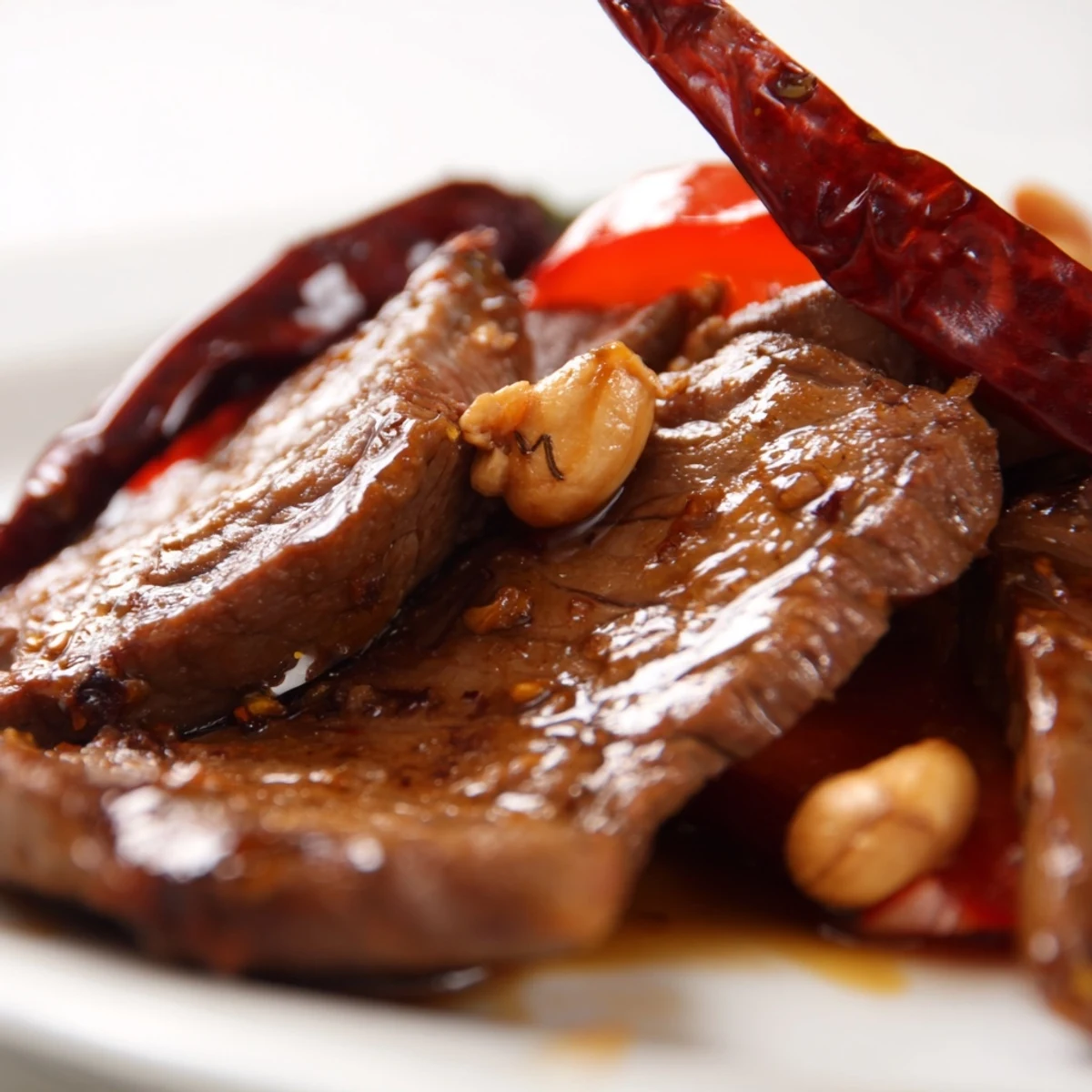Tender strips of marinated beef sear alongside crisp vegetables in the bold sauce of this homemade Spicy Szechuan Beef with Peanuts.
