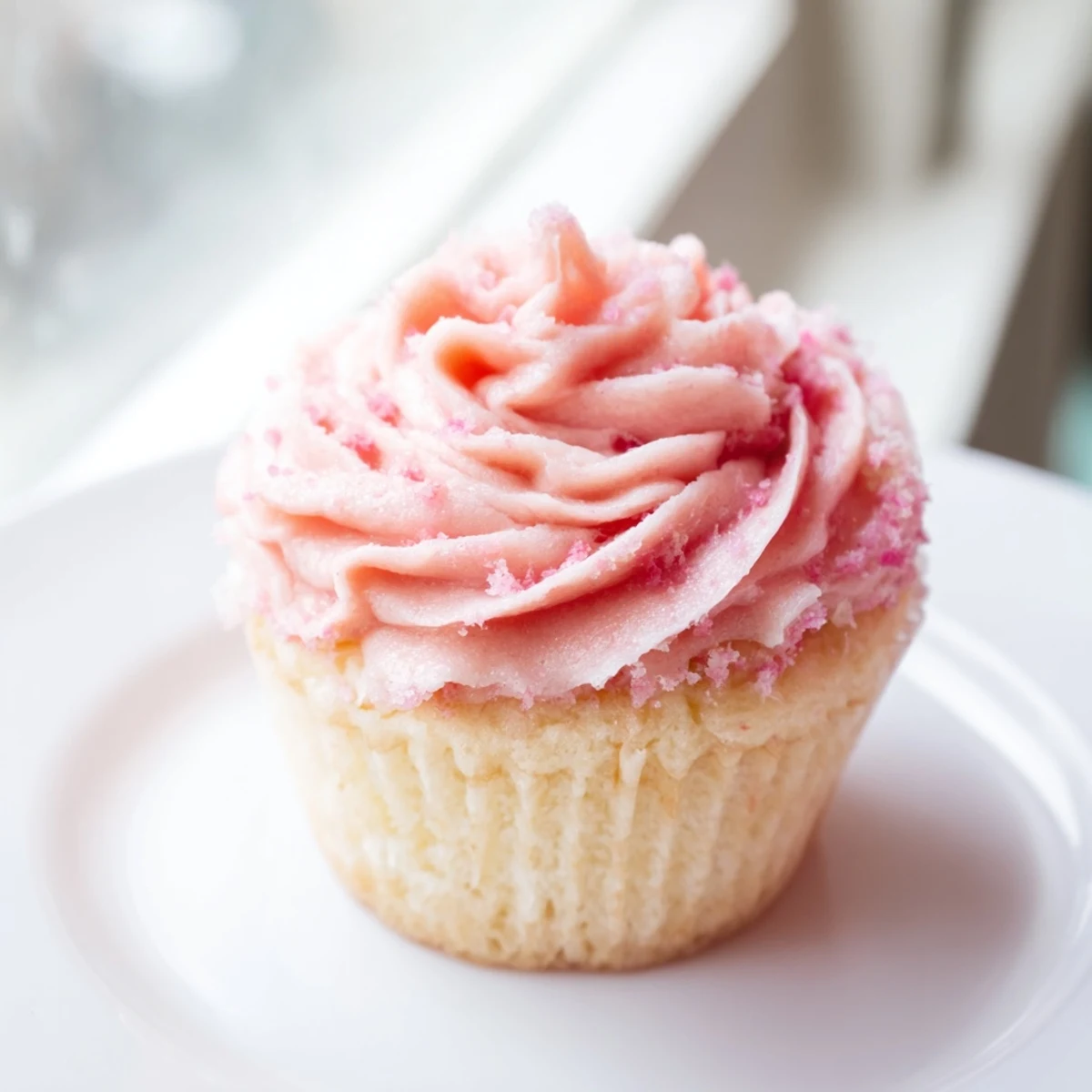 Easy-to-make, alcohol-free Valentine Pink Champagne Cupcakes topped with swirls of pastel pink buttercream, perfect for sharing.