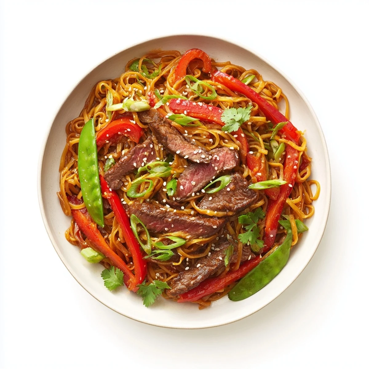 Overhead view of Spicy Beef Stir Fry with Noodles, showing vibrant vegetables and tender beef intertwined with egg noodles, ready to be enjoyed with chopsticks.