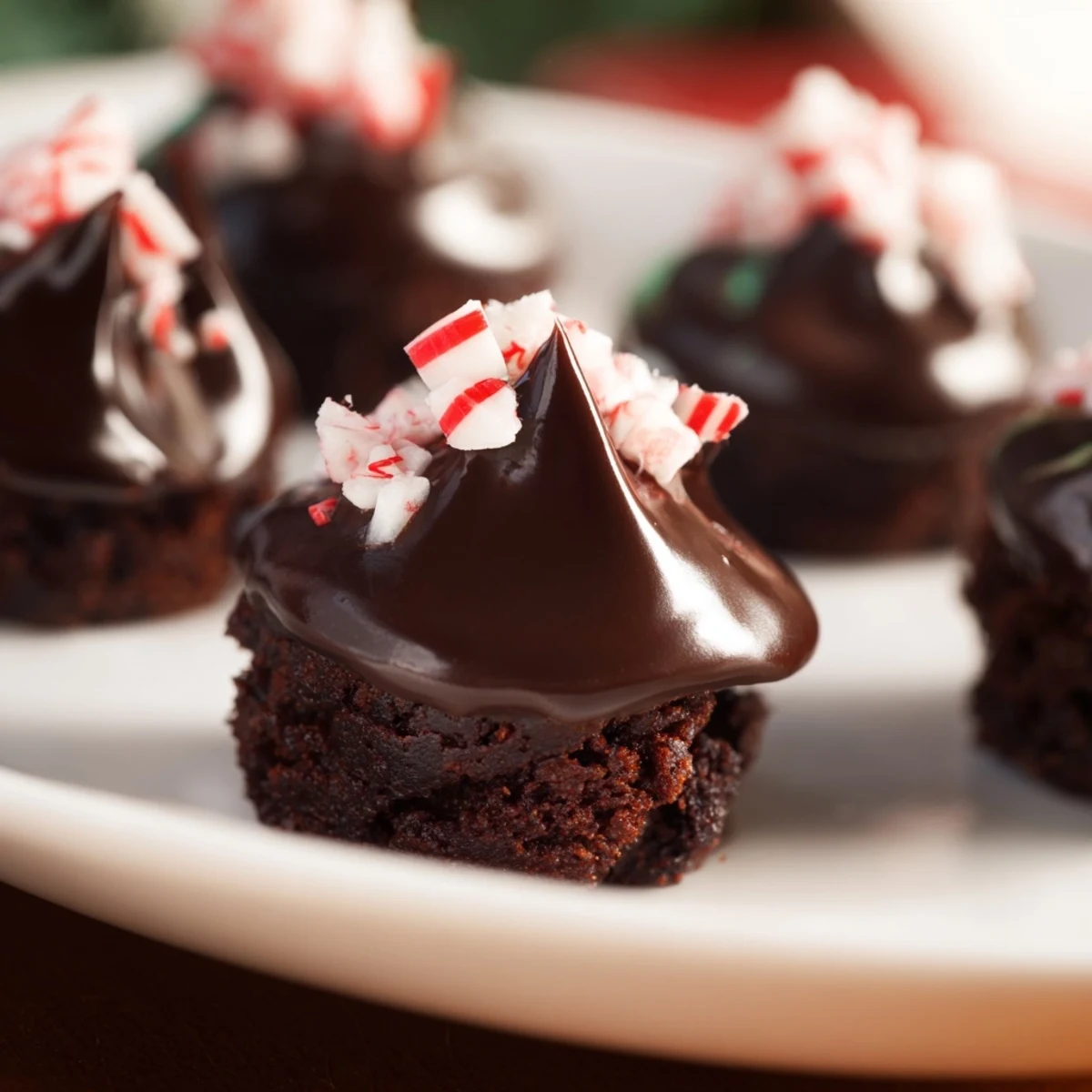 Freshly baked Mint Brownie Bites topped with a rich ganache and dusted with cocoa powder.