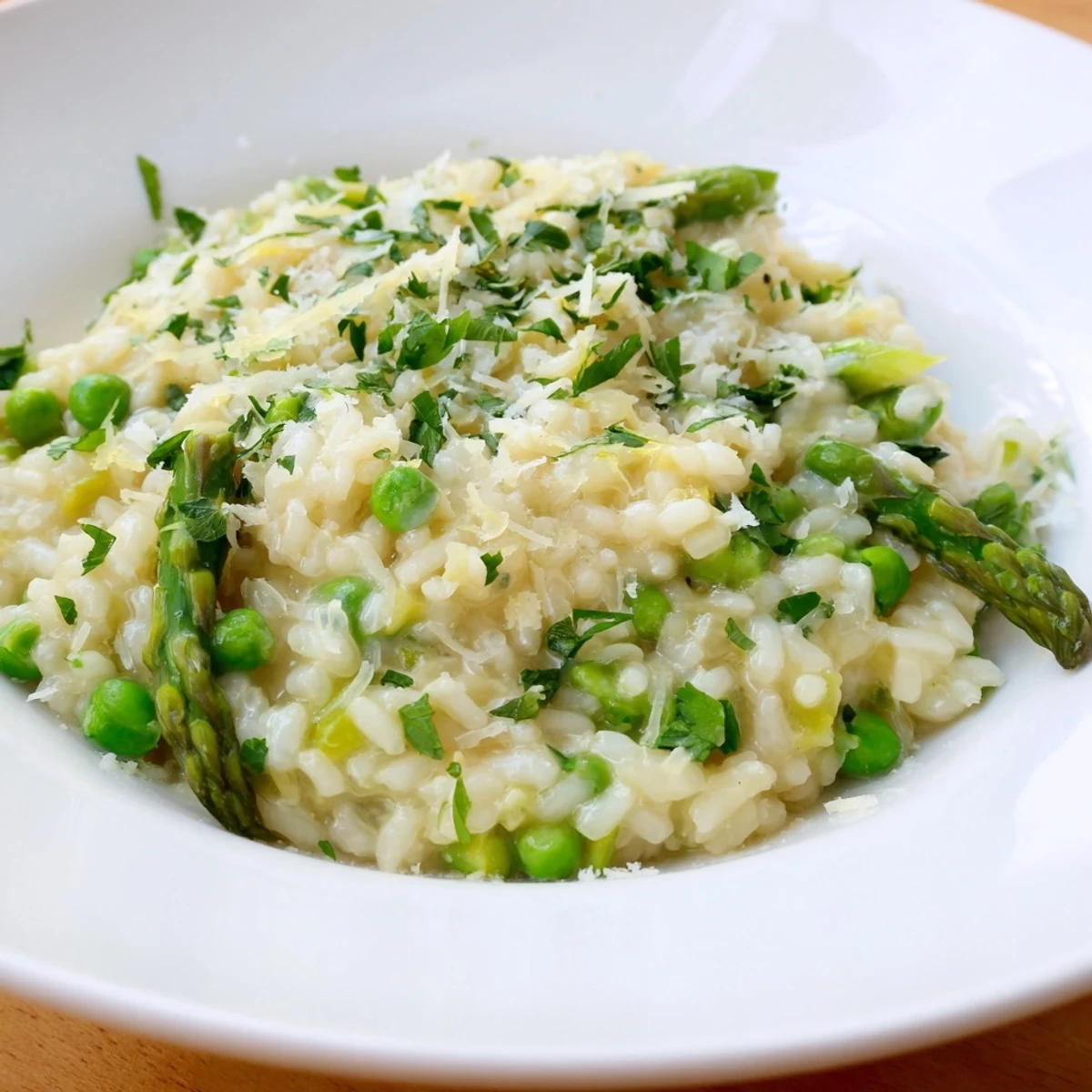 Freshly cooked Spring Pea and Asparagus Risotto in a skillet, blending Arborio rice with vegetables and a Parmesan finish.