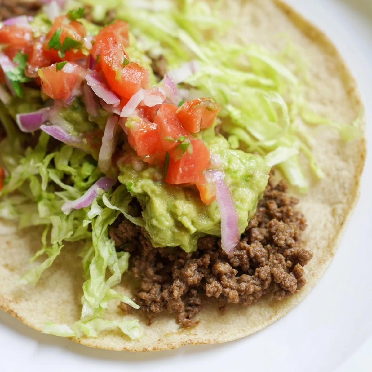 Vibrant Beef Tacos with Homemade Salsa and Guacamole feature golden tortillas filled with spiced beef, topped with zesty tomato salsa and rich avocado guacamole.