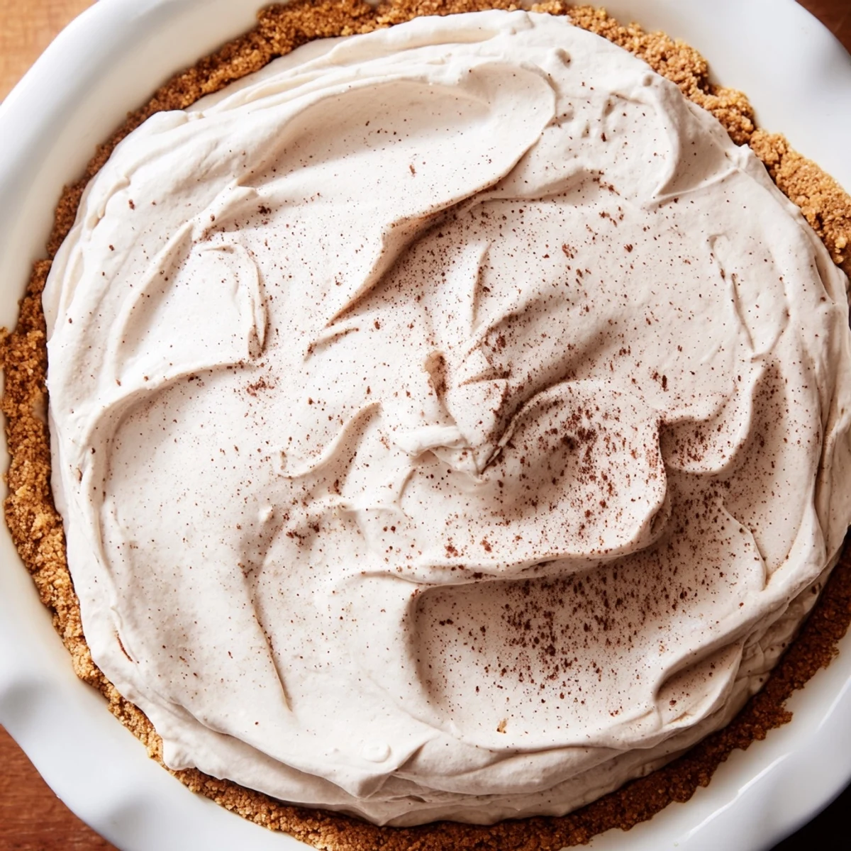 Slice of keto cold brew coffee pie served chilled, featuring a smooth filling and golden crust.  