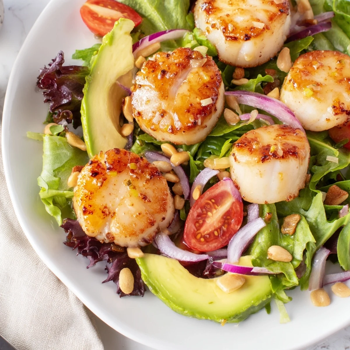 For a romantic dinner, Pan Seared Scallops Romantic Dinner Salad features succulent scallops with avocado and pine nuts.