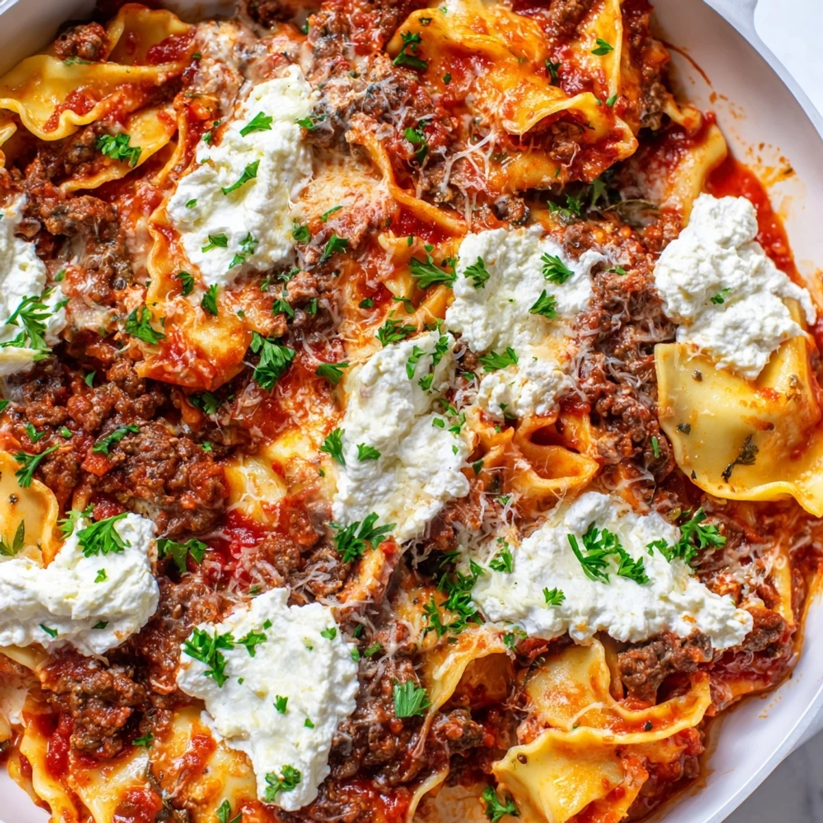 Hearty skillet lasagna in a pan with melty mozzarella, ricotta, and rich meat sauce on a rustic table.