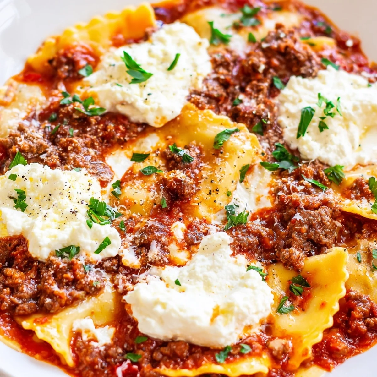 Bubbling skillet lasagna with broken noodles, ground beef, and fresh basil garnish on a wooden cutting board.