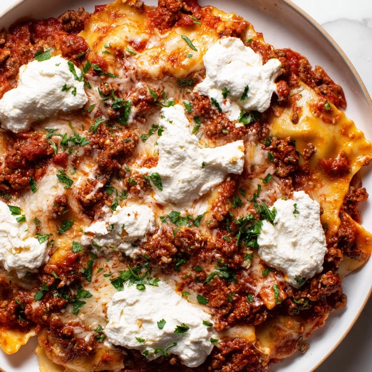 Serving spoon lifting cheesy skillet lasagna from a deep pan, showing steam and red tomato sauce for weeknight dinner.