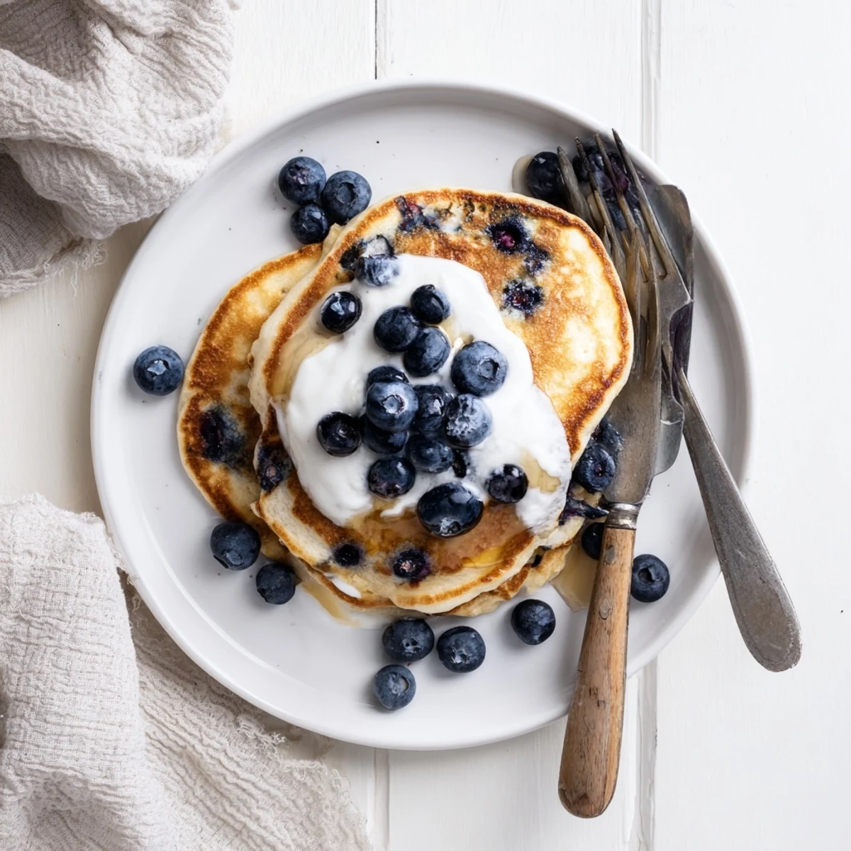 Warm Greek Yogurt Blueberry Pancakes beside a cup of coffee, perfect American breakfast spread