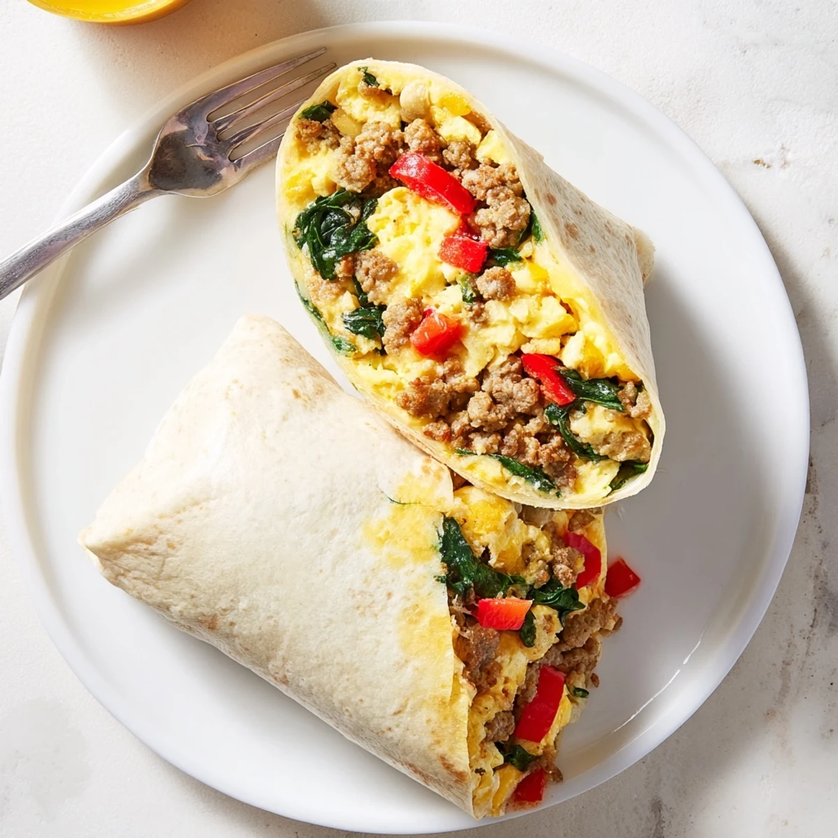 Make-Ahead Breakfast Burritos wrapped in foil ready for freezing and quick reheating on busy mornings.