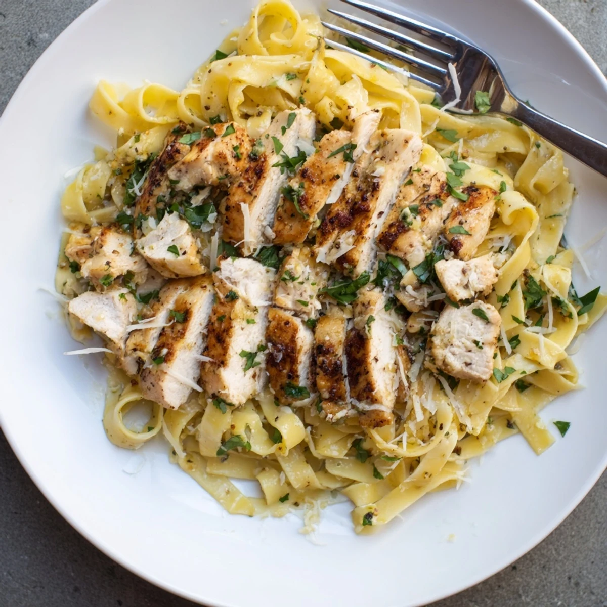 Tender seasoned chicken breasts cooked atop glossy egg noodles in a single skillet for easy weeknight dining