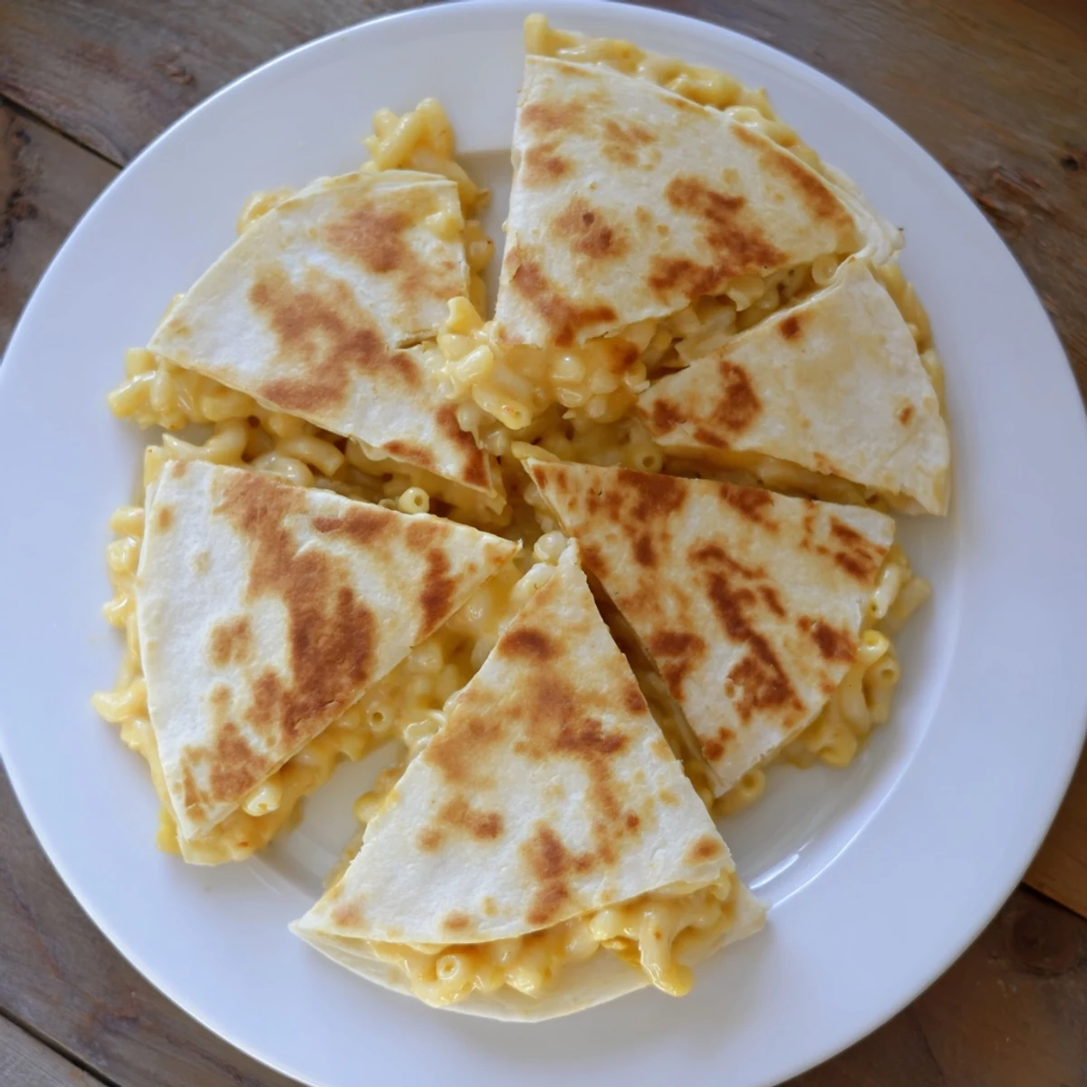 Oven-baked mac and cheese quesadillas with melted cheddar oozing from golden tortilla edges