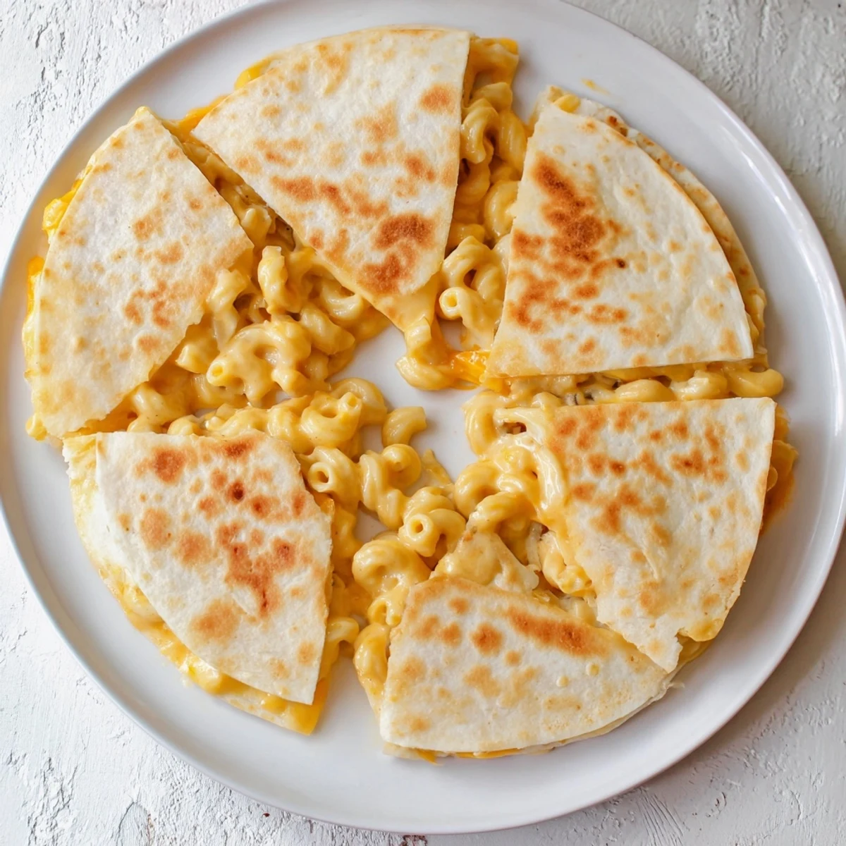 Homemade mac and cheese quesadillas served with salsa and sour cream for dipping