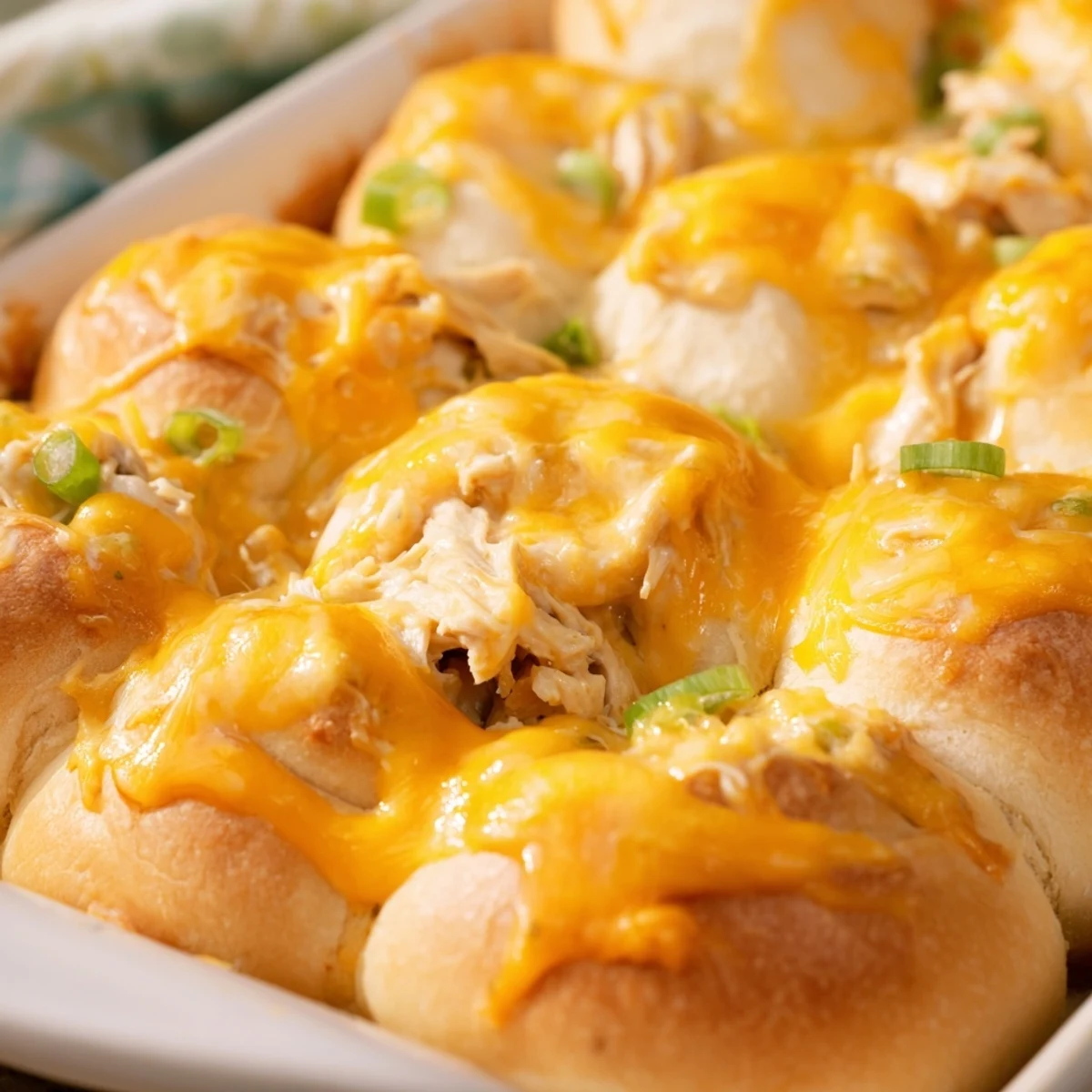 Family-friendly cheesy chicken crescent bake featuring tender filling wrapped in golden buttery pastry