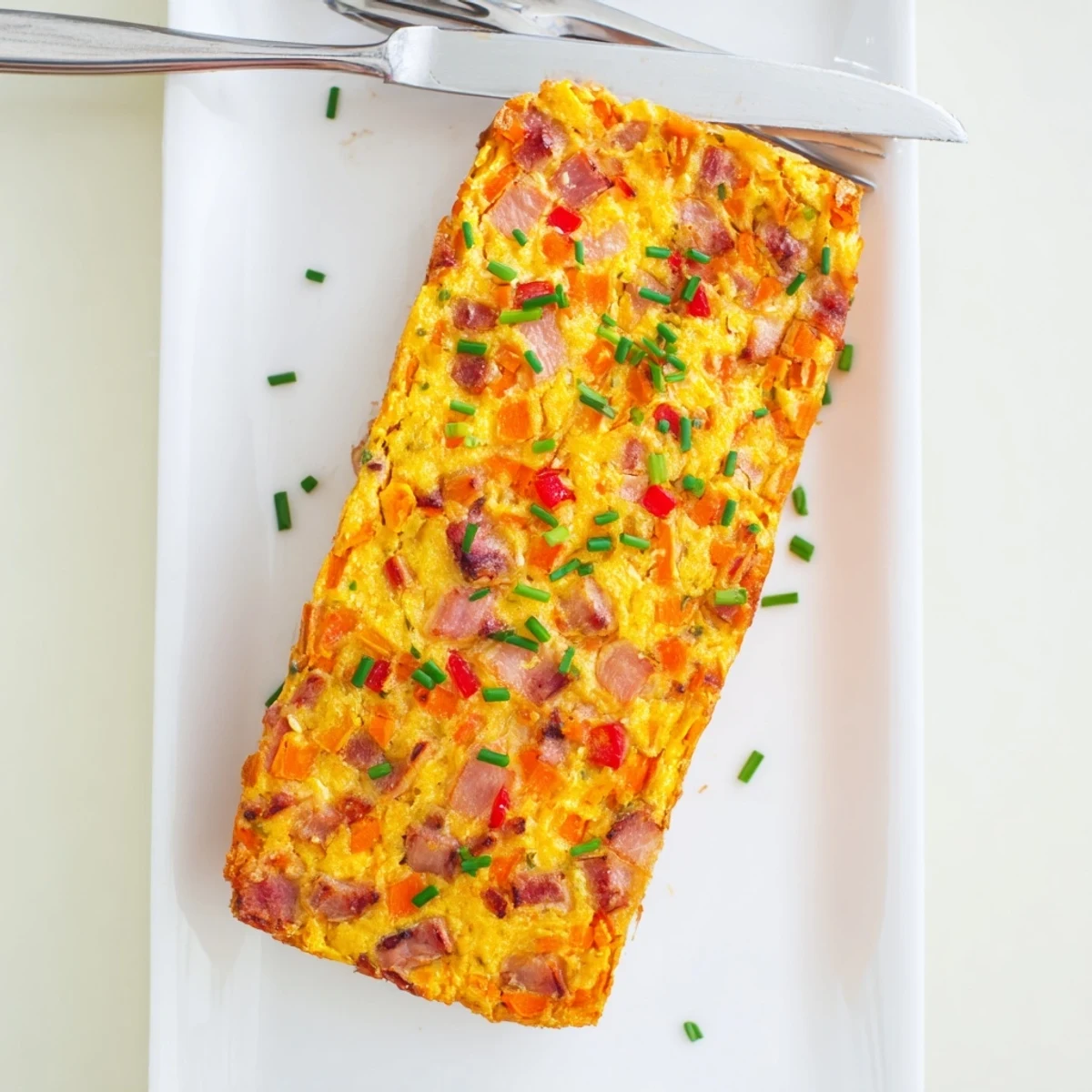 Homemade vegetable and ham slice cut into thick pieces revealing vibrant vegetable layers inside