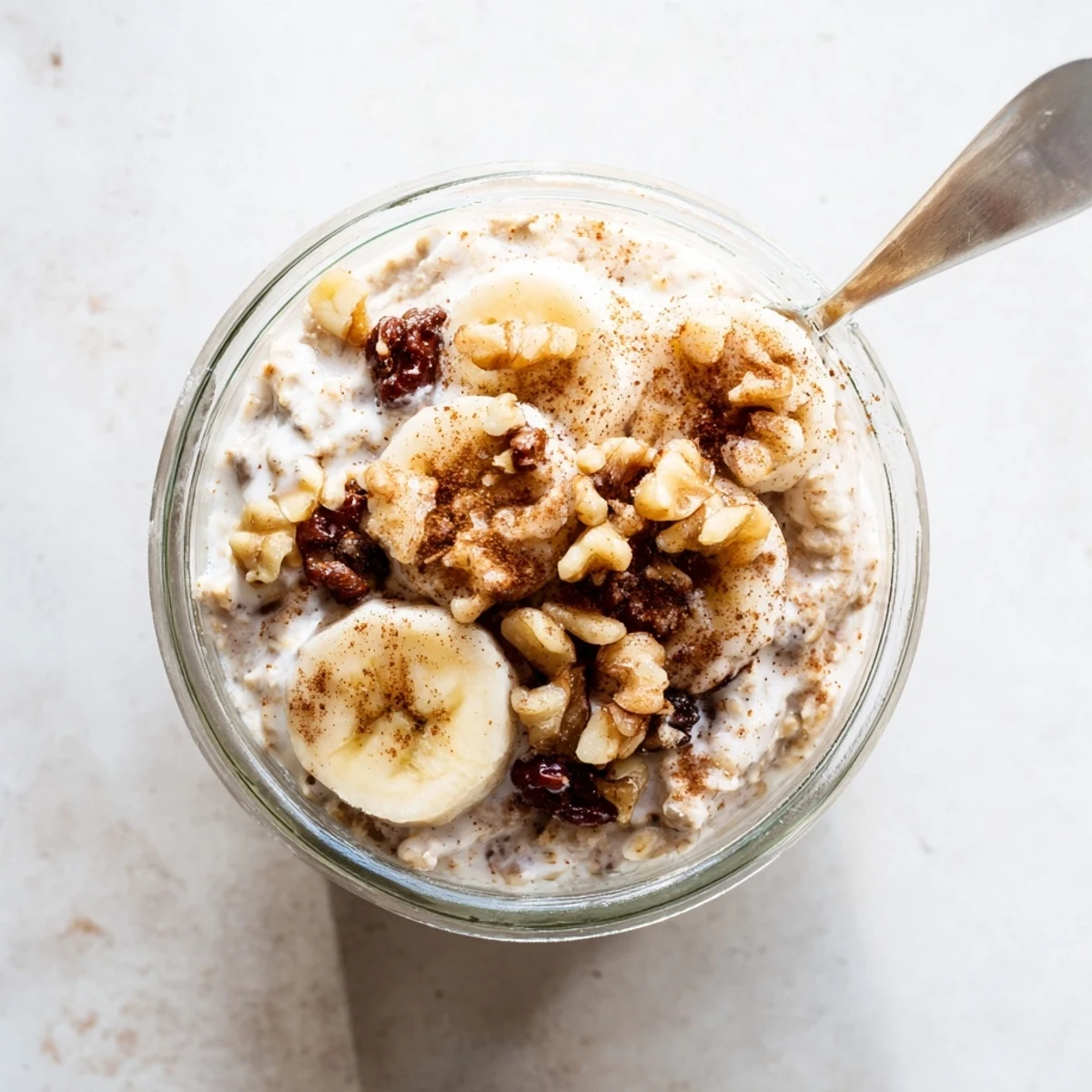 Wholesome brown sugar overnight oats breakfast bowl with milk, vanilla, and pecan garnish on wooden table.