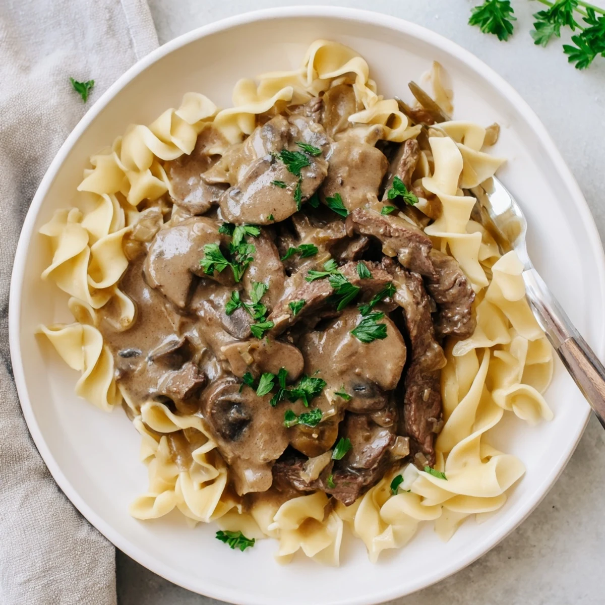 Tender beef strips in rich mushroom sauce atop steaming white rice
