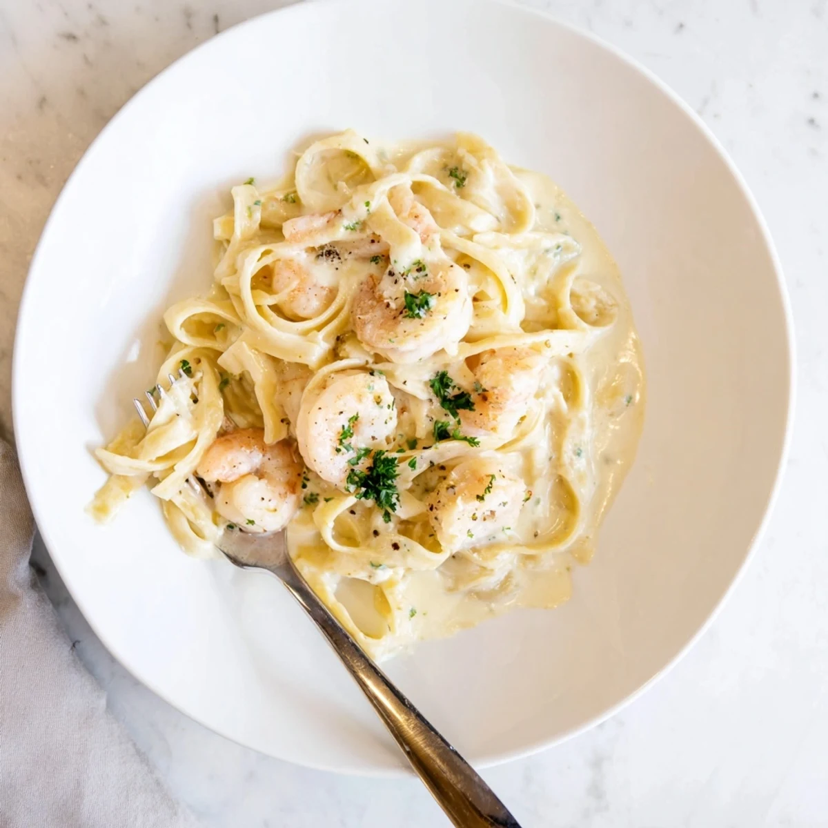 Sizzling skillet of one pan shrimp fettuccine Alfredo showcasing golden shrimp coated in velvety cream and melted Parmesan