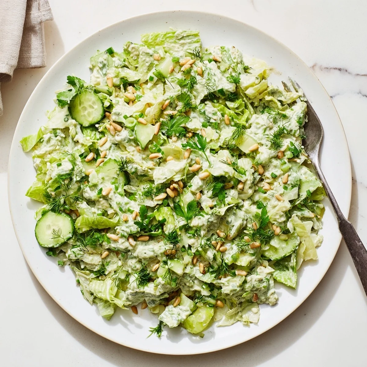 Colorful Green Goddess Salad bowl with chopped vegetables and creamy herb dressing topping crisp lettuce and cucumber