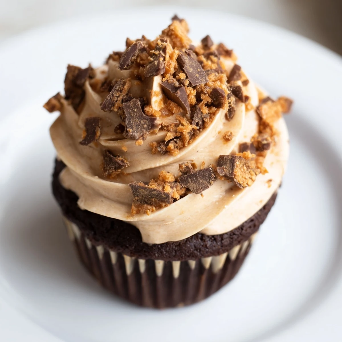 Rich chocolate cupcakes filled with smooth peanut butter and sprinkled with crushed Butterfinger candy