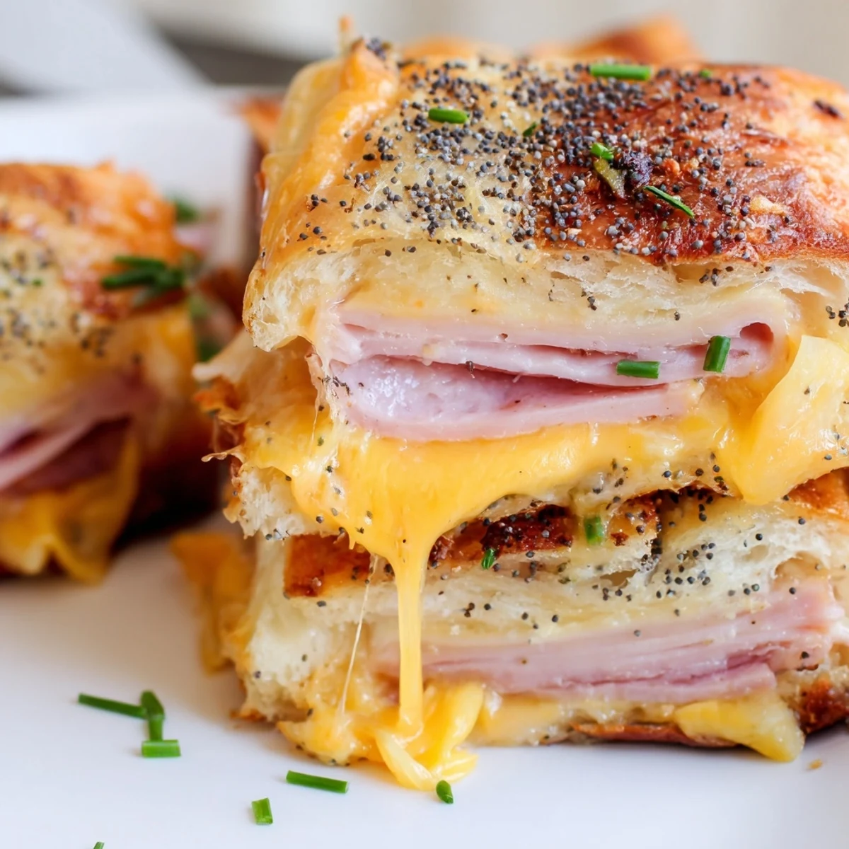 Sweet savory grilled cheese sandwiches featuring Hawaiian rolls, ham, and crispy buttered exteriors