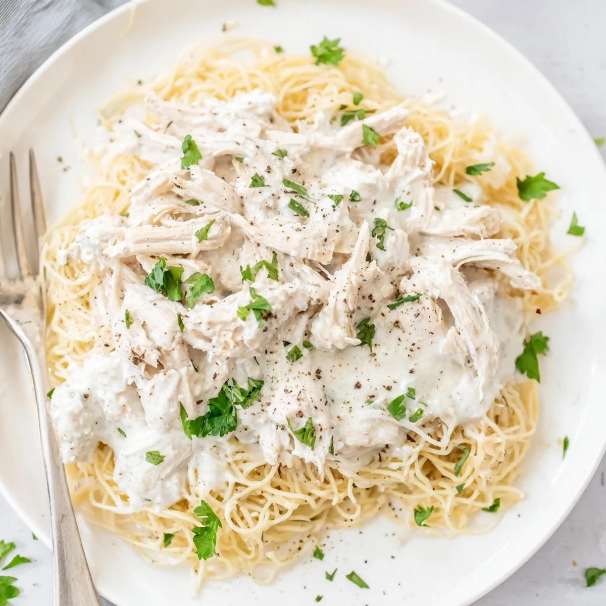 Juicy chicken breasts in rich Italian cream sauce atop tender white pasta