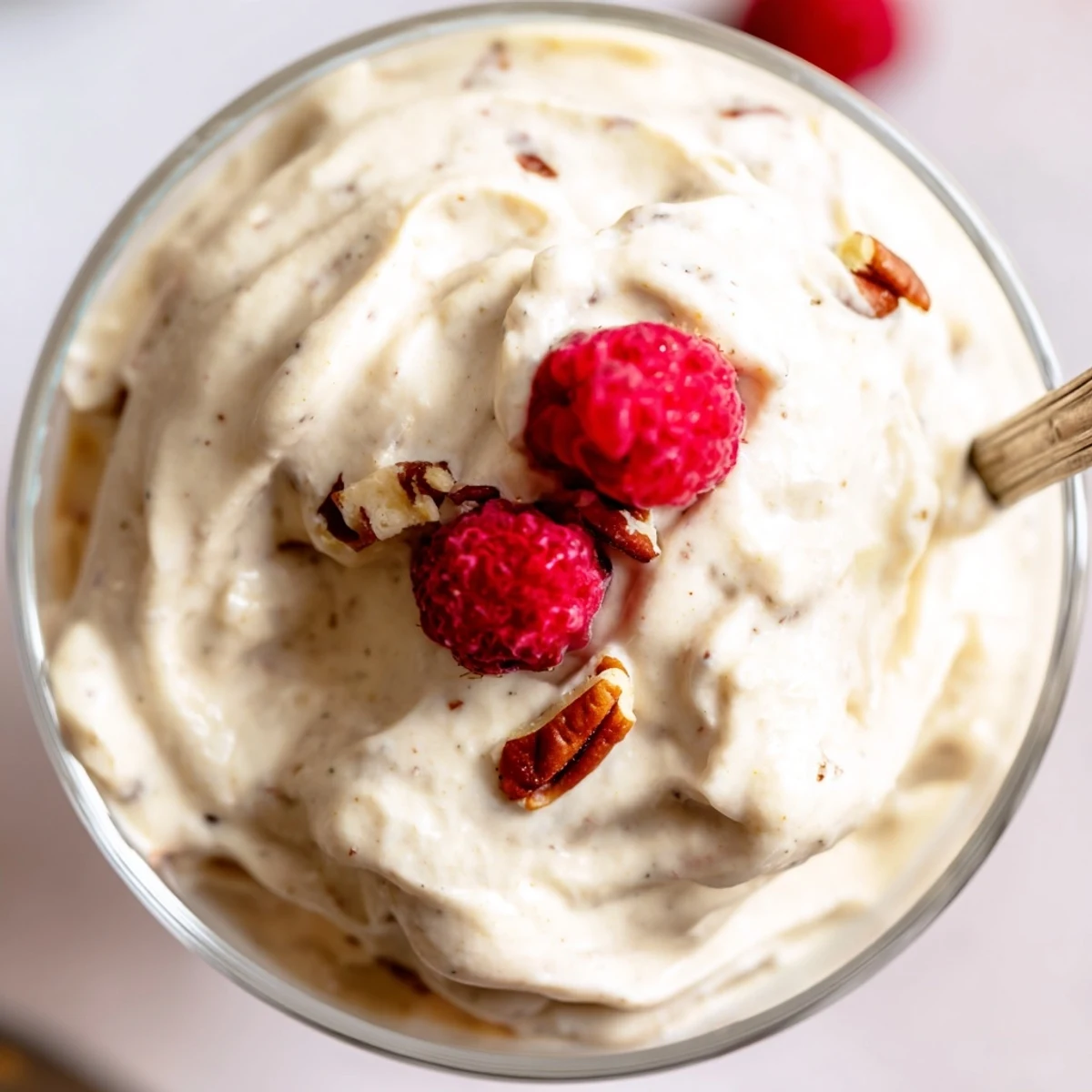 Light and airy keto cheesecake fluff swirled with vanilla and garnished with chopped nuts