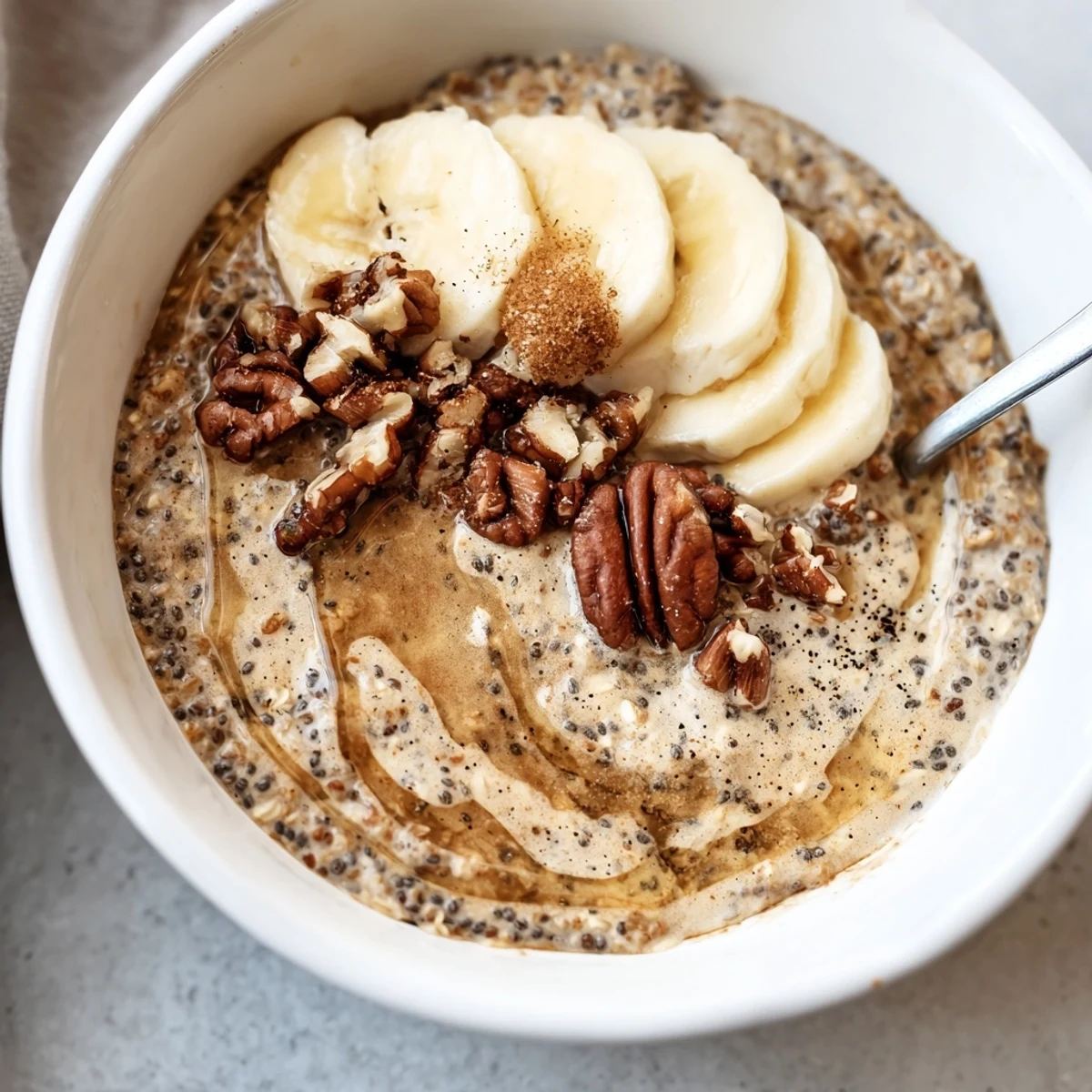 Creamy Brown Sugar Coffee Overnight Oats topped with sliced banana and toasted pecans