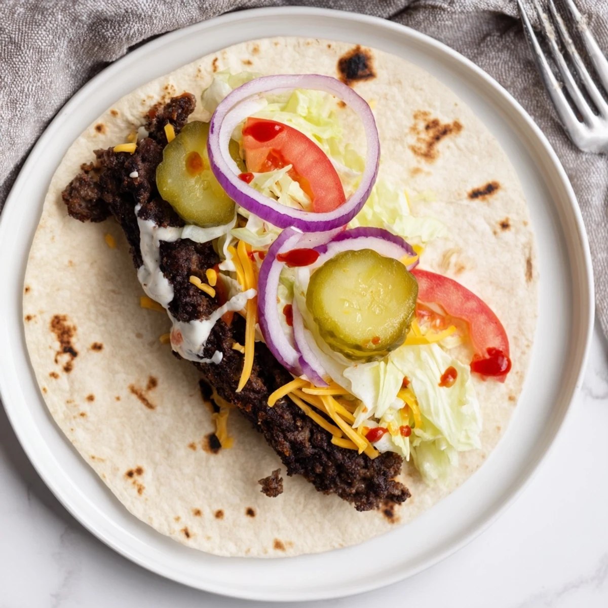 Smash Burger Tacos Recipe with crispy browned beef, melted cheddar, fresh toppings.