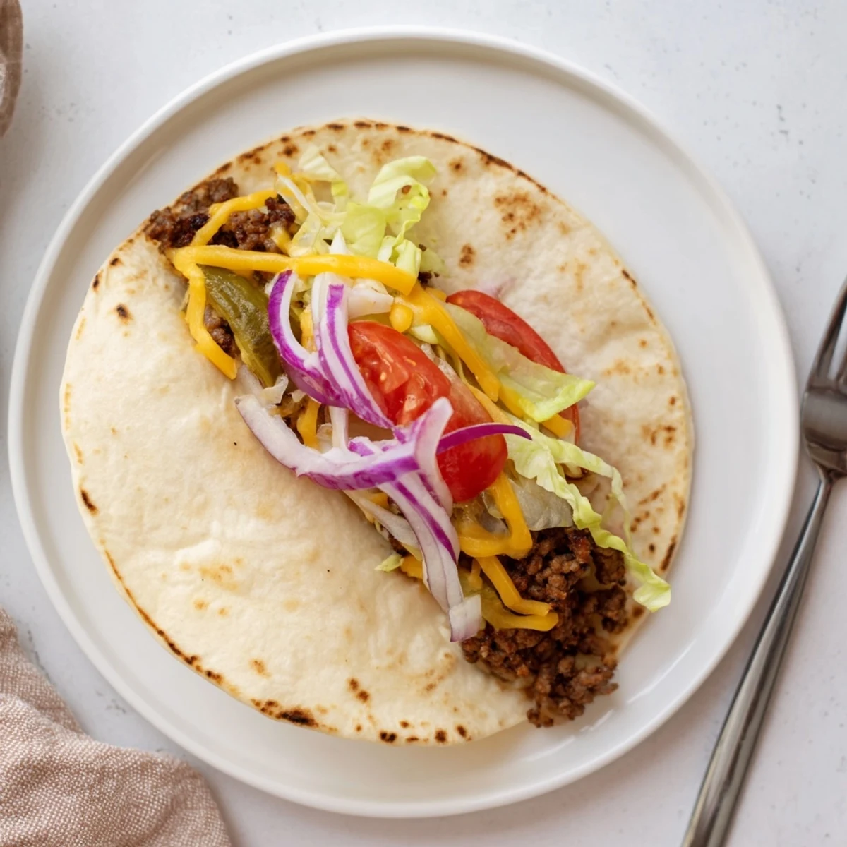 Skillet-seared Smash Burger Tacos Recipe: thin crispy edges, gooey cheese melt.