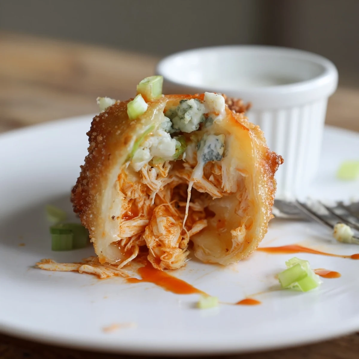 Tray of freshly fried Buffalo Chicken Egg Rolls Recipe cooling, paired with cold lager