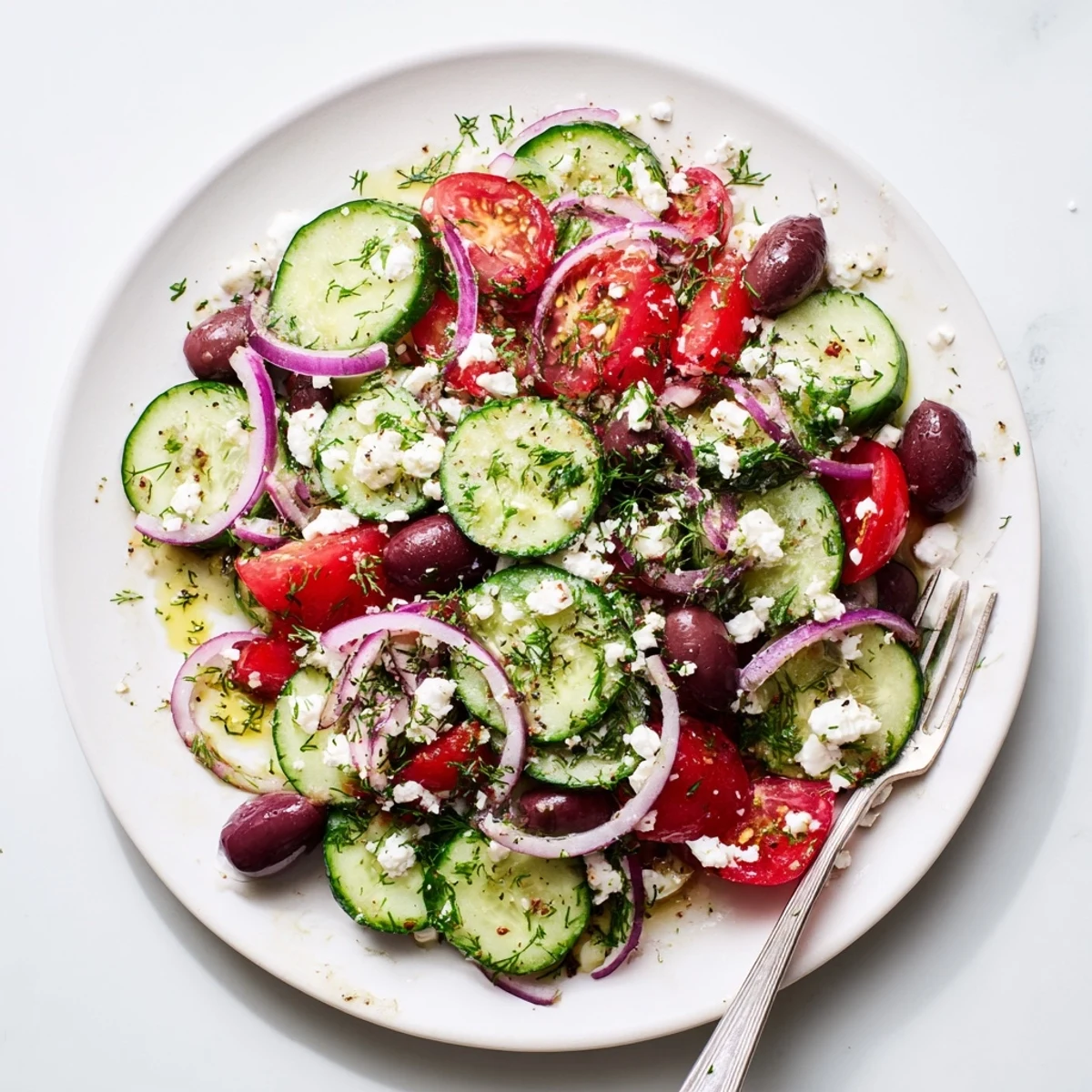 Fresh Mediterranean cucumber salad bowl with crisp vegetables, feta cheese, and zesty lemon dressing
