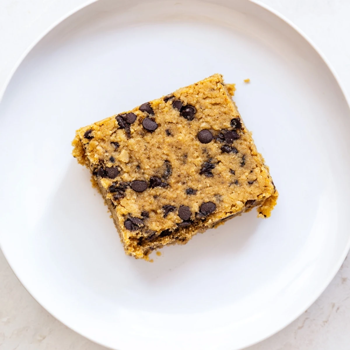 Freshly baked flourless peanut butter banana treats cooling on wire rack with flaky sea salt garnish