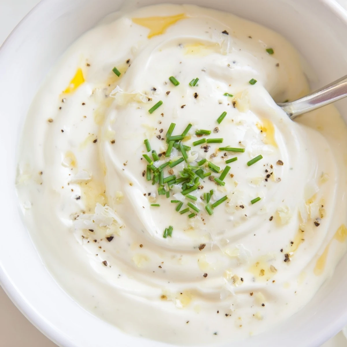 Creamy Tangy Sauce dolloped on sandwich, cool tang cutting through rich mayo