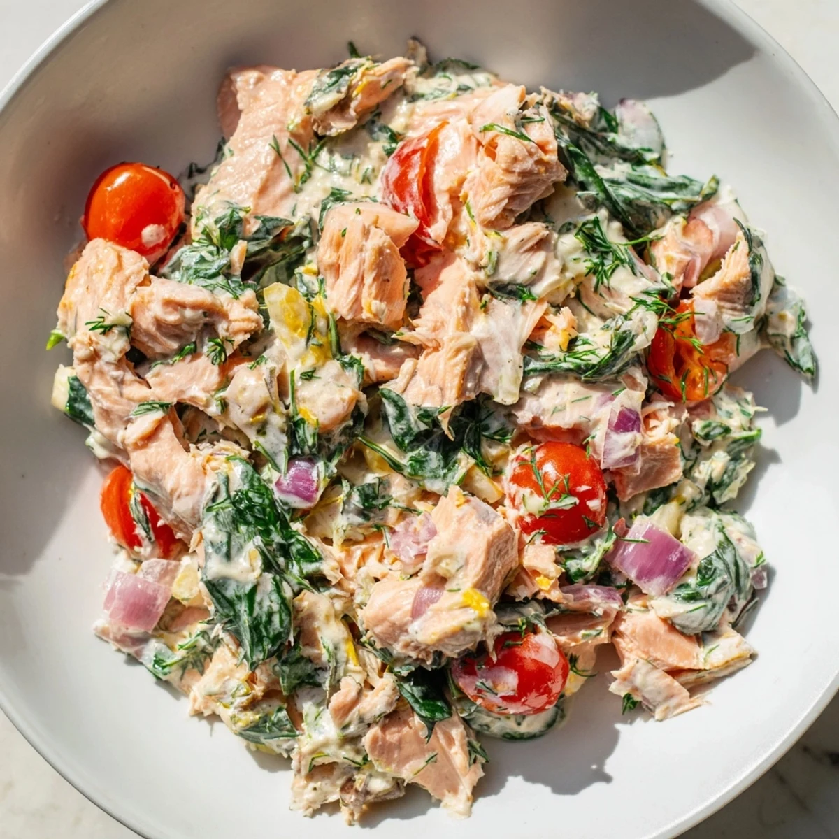 Creamy leftover salmon recipe topped with bright cherry tomatoes and fresh dill.