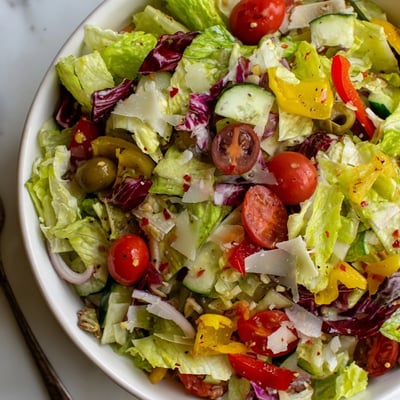 Bright, colorful Zesty Italian Chopped Salad With Parmesan And Peppers tossed in dressing