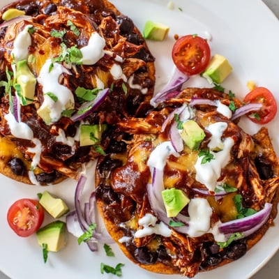 Golden tostada shells topped with tender sweet smoky BBQ chicken and colorful vegetables